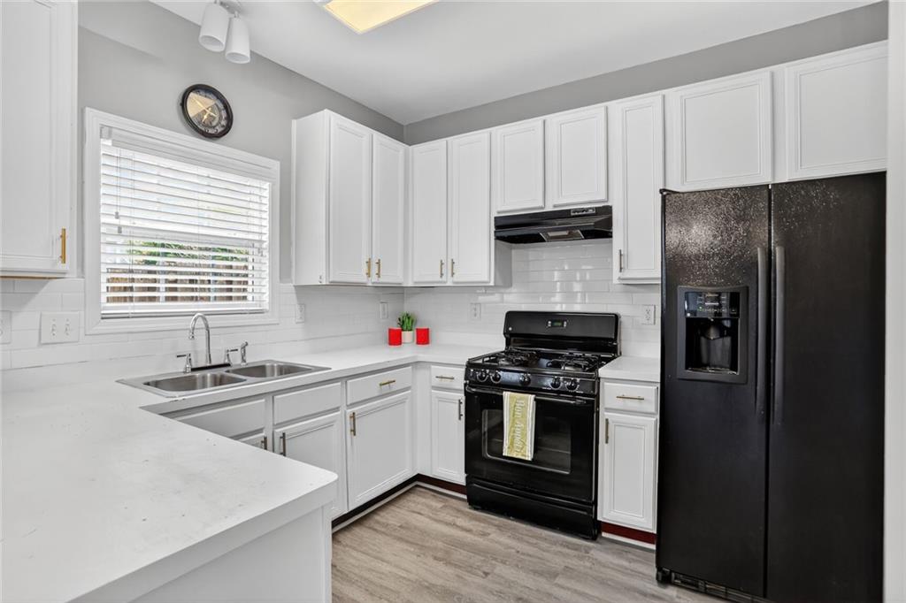 230 Valley Crossing Canton, GA 30114 - Photo 5 of 21 a kitchen with a sink stove and refrigerator