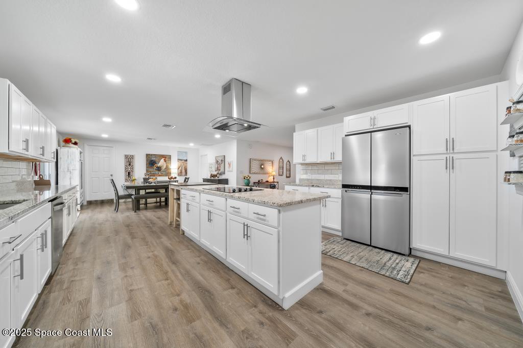 1253 St Andrews Drive Rockledge, FL 32955 - Photo 16 of 33 a kitchen with stainless steel appliances a refrigerator sink and cabinets