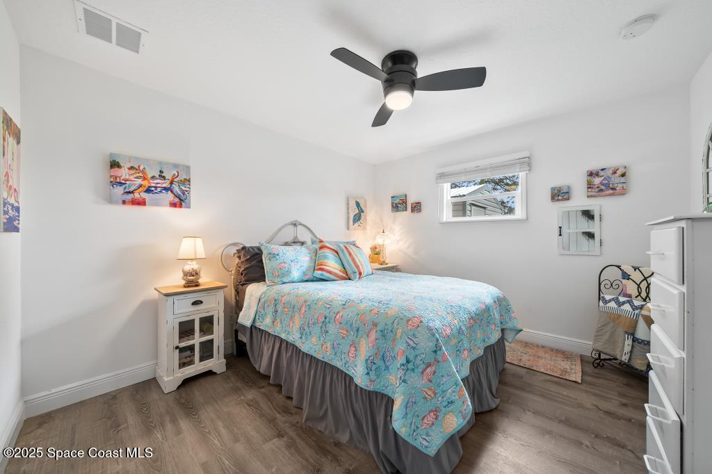 1253 St Andrews Drive Rockledge, FL 32955 - Photo 20 of 33 a bedroom with a bed and a chandelier