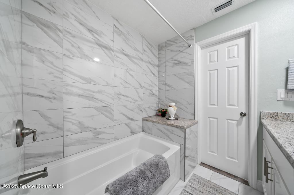 1253 St Andrews Drive Rockledge, FL 32955 - Photo 22 of 33 a bathroom with a bathtub and shower