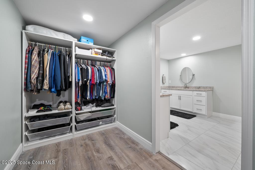 1253 St Andrews Drive Rockledge, FL 32955 - Photo 27 of 33 a view of walk in closet with clothes and shoes