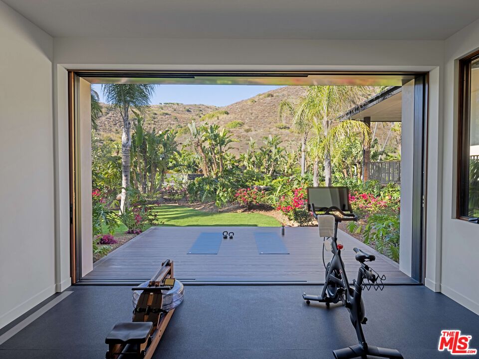 11809 Ellice Street Malibu, CA 90265 - Photo 25 of 39 a room with wooden floor and windows