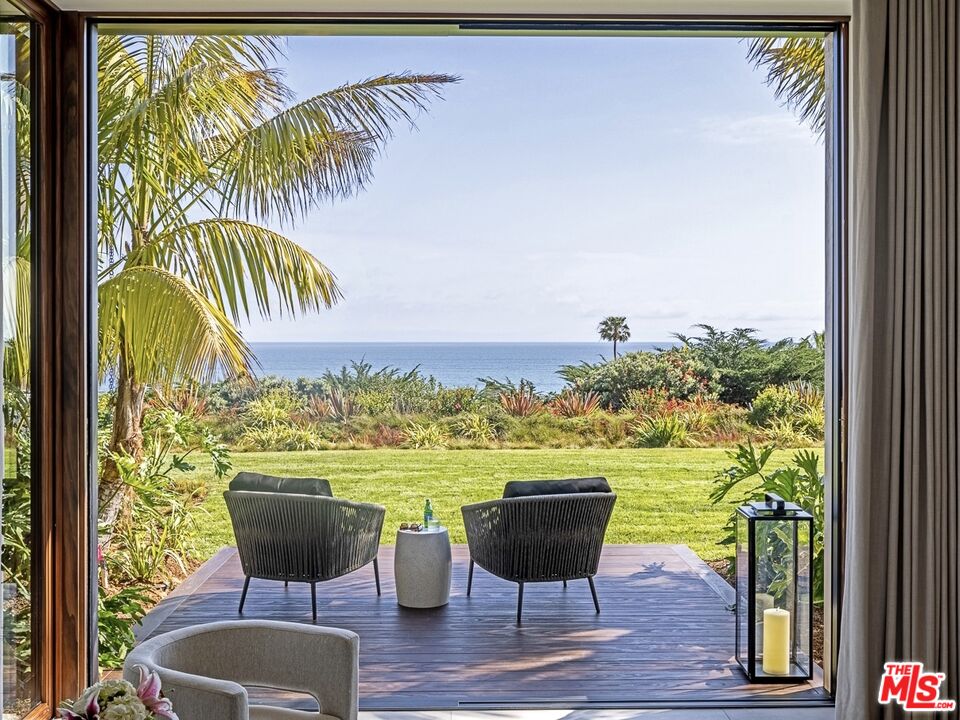 11809 Ellice Street Malibu, CA 90265 - Photo 28 of 39 a view of a chairs and table in a balcony