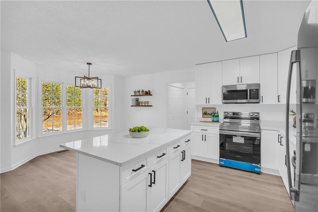 2693 Highway 101 Temple, GA 30179 - Photo 15 of 69 a kitchen with stainless steel appliances a stove a sink and a refrigerator