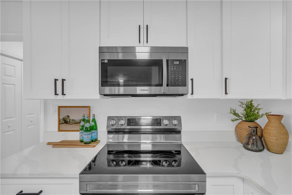 2693 Highway 101 Temple, GA 30179 - Photo 18 of 69 a kitchen with stainless steel appliances granite countertop a stove a microwave and cabinets