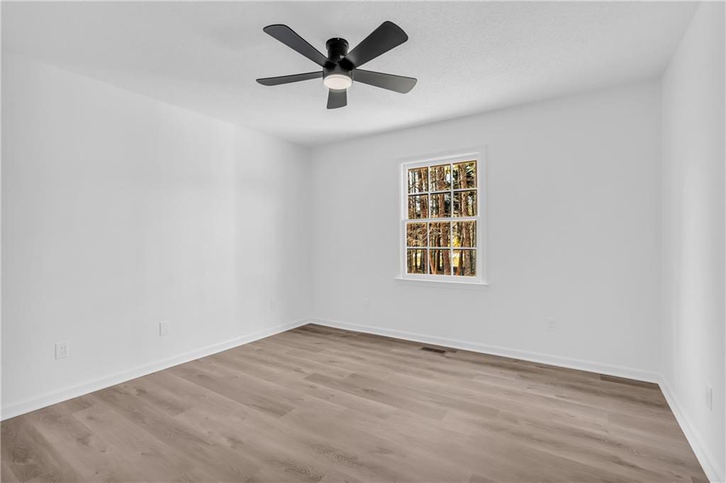 2693 Highway 101 Temple, GA 30179 - Photo 30 of 69 an empty room with wooden floor and windows