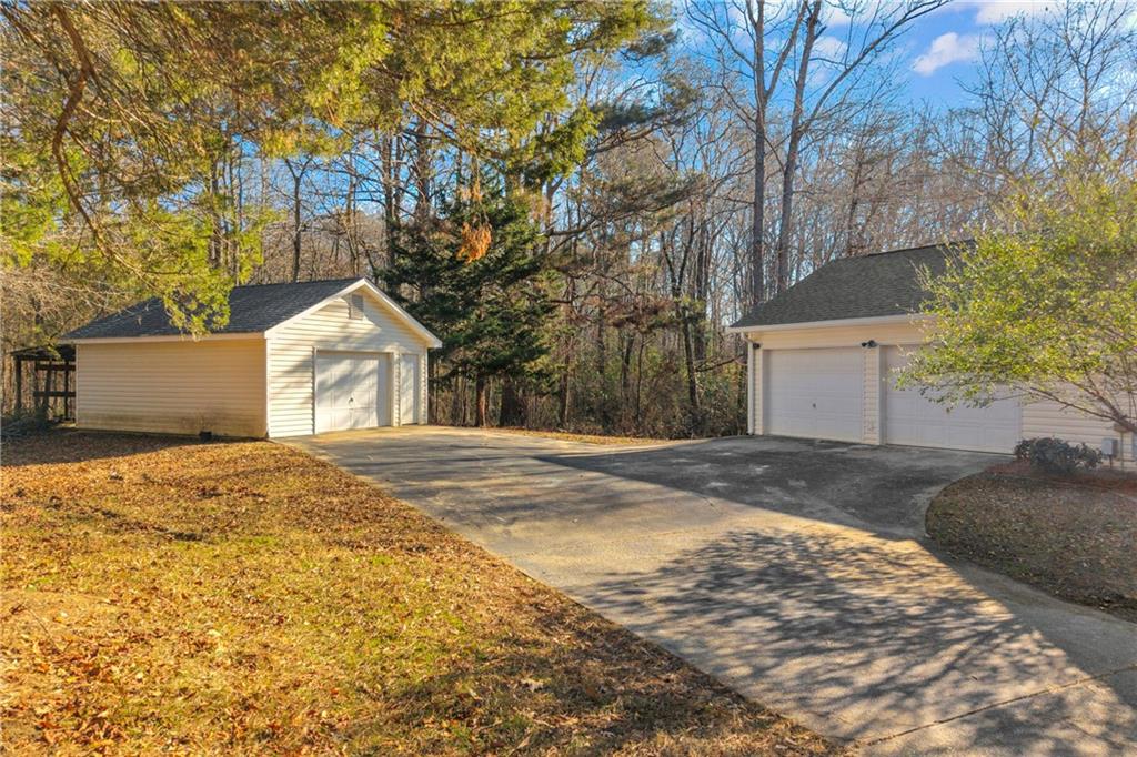 2693 Highway 101 Temple, GA 30179 - Photo 57 of 69 a front view of a house with a yard and garage