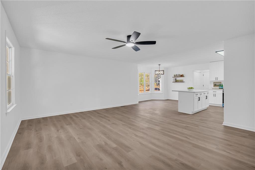 2693 Highway 101 Temple, GA 30179 - Photo 8 of 69 a view of a kitchen with wooden floor and a ceiling fan