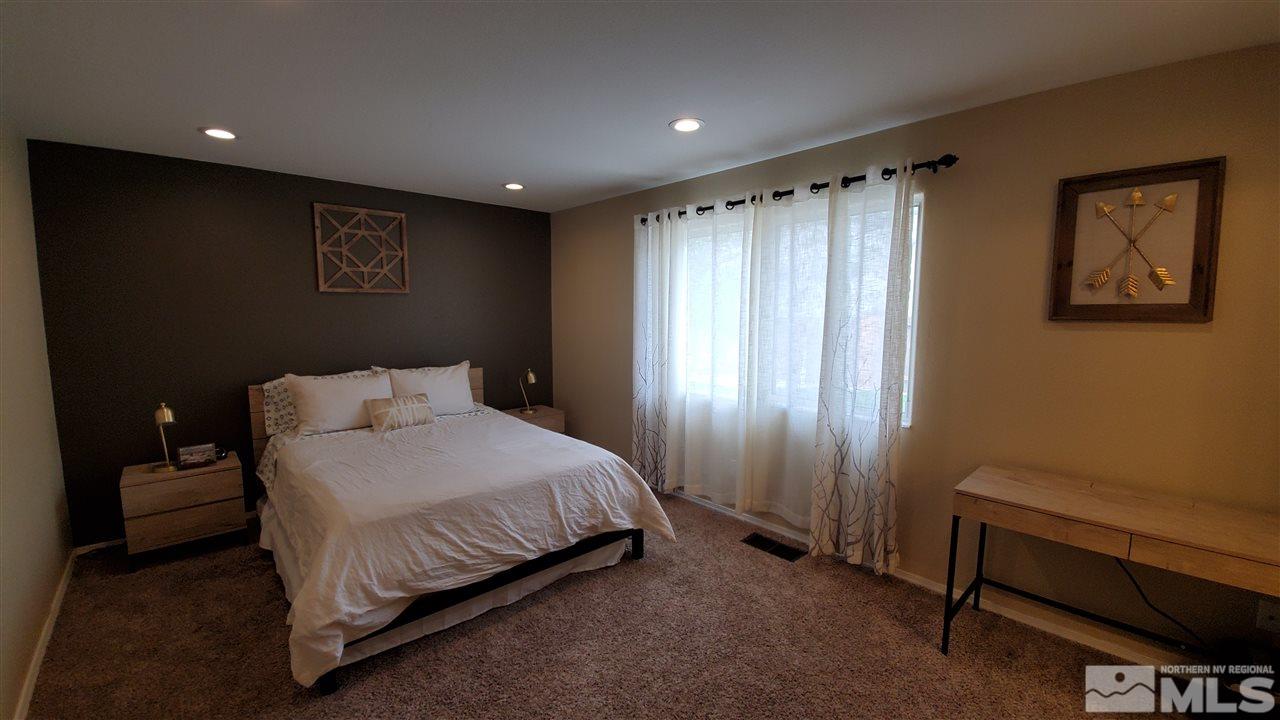 4580 Goodwin Road Sparks, NV 89436 - Photo 10 of 12 a spacious bedroom with a bed and a window