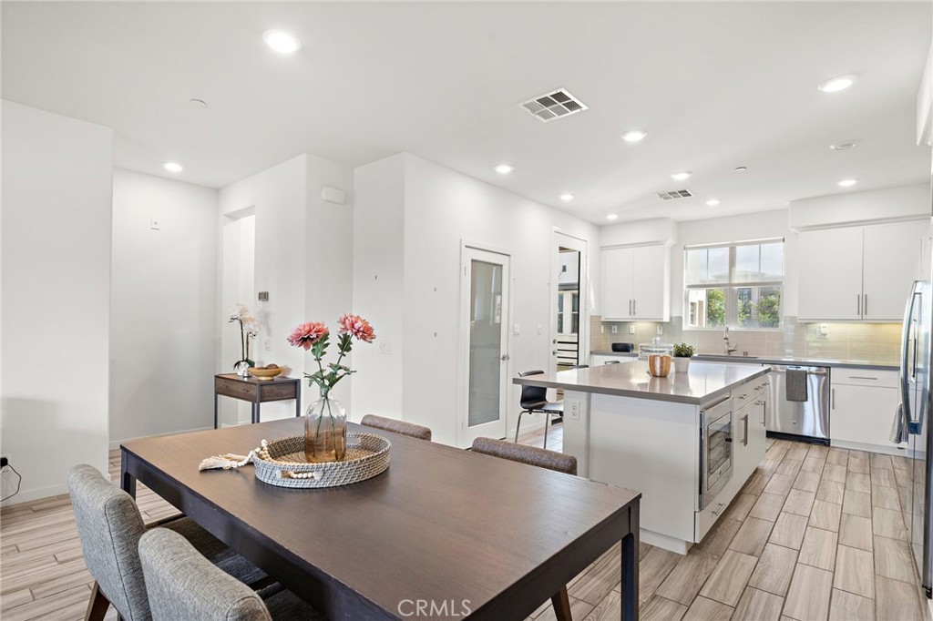 144 Paramount Irvine, CA 92618 - Photo 8 of 43 a view of a dining room with furniture and chandelier