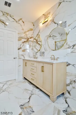 a bathroom with a sink mirror and a shower