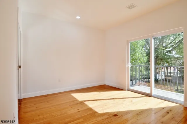 a bedroom with a bed a mirror and dresser