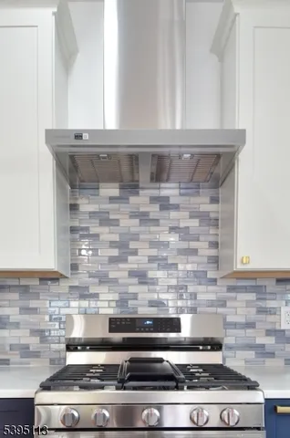 a bathroom with a granite countertop sink mirror and bathtub