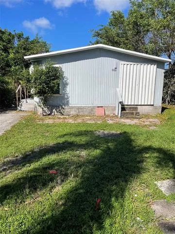 a view of a backyard with plants and a patio