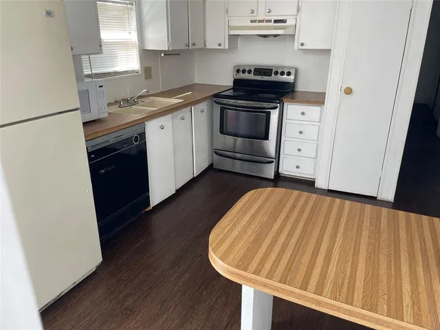 a kitchen with stainless steel appliances a stove a sink and a refrigerator