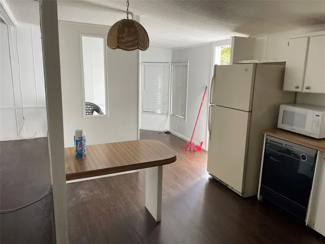 a kitchen with stainless steel appliances a refrigerator and a stove top oven