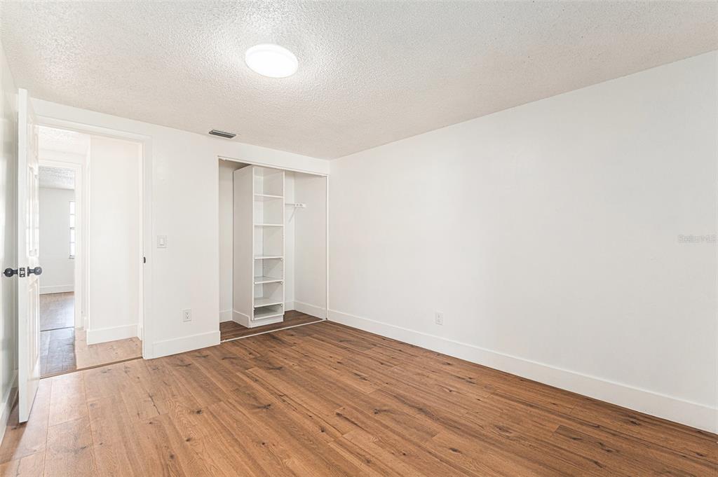 16147 Sagebrush Road Tampa, FL 33618 - Photo 12 of 18 a view of a room with wooden floor and white walls