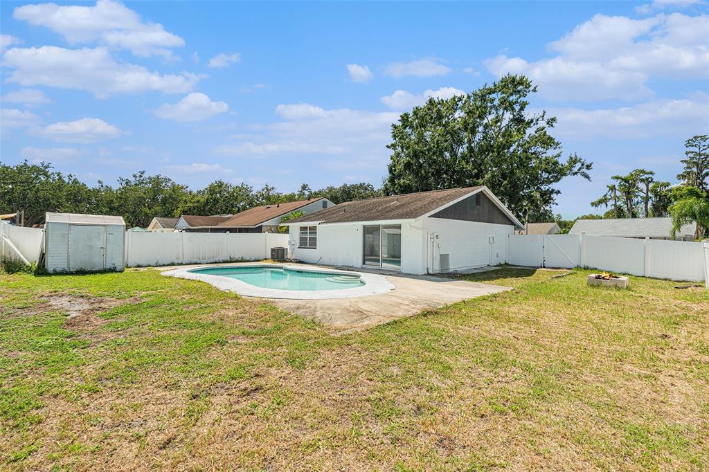 16147 Sagebrush Road Tampa, FL 33618 - Photo 18 of 18 a bathroom with a tub and trees in the background