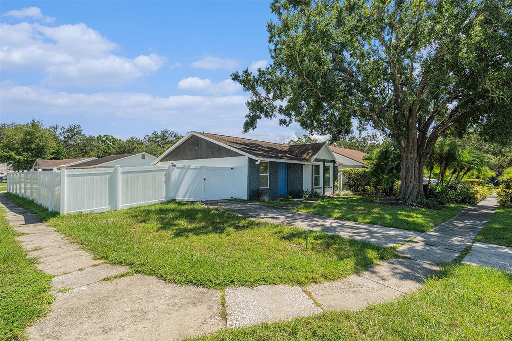 16147 Sagebrush Road Tampa, FL 33618 - Photo 2 of 18 a front view of a house with a yard and trees