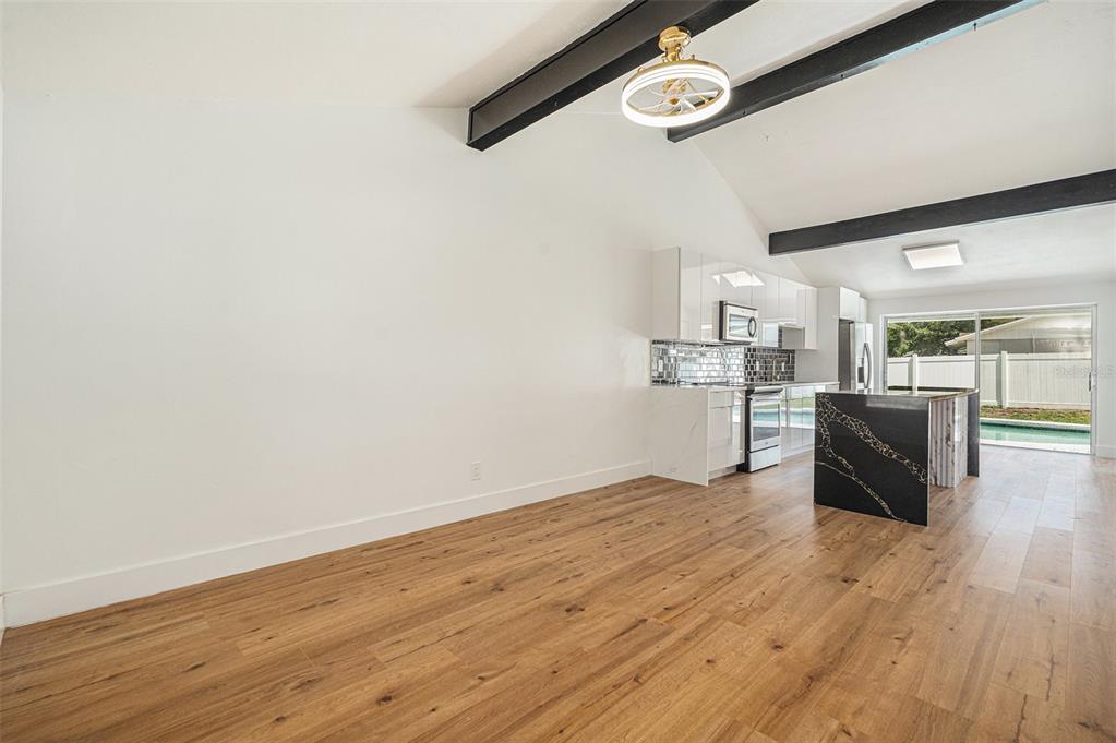 16147 Sagebrush Road Tampa, FL 33618 - Photo 4 of 18 a kitchen with stainless steel appliances wooden floor and view living room