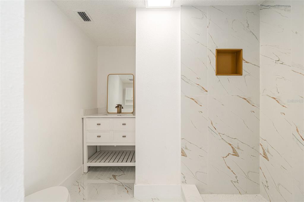 16147 Sagebrush Road Tampa, FL 33618 - Photo 10 of 18 a bathroom with a sink and a mirror