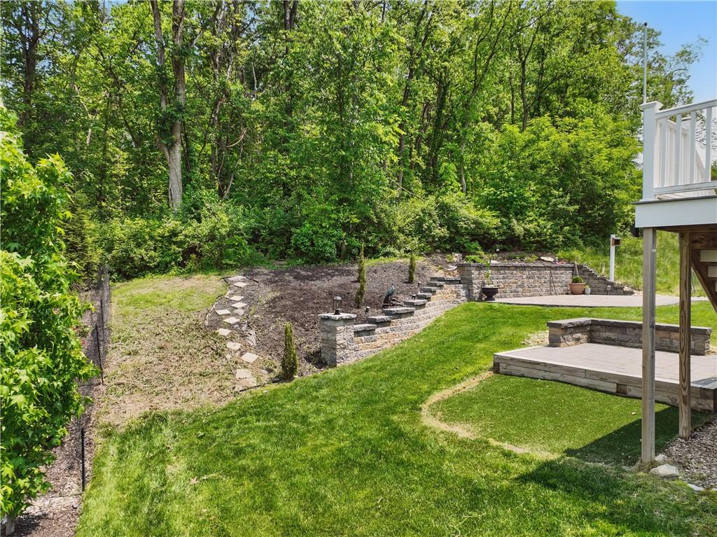 150 Cole Drive McKees Rocks, PA 15136 - Photo 42 of 49 Landscaping wall and yard lined by trees.