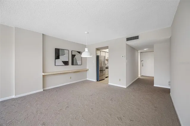 a view of a livingroom with wooden floor and cabinet