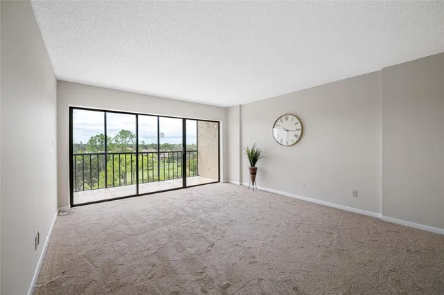 a view of an empty room and a window