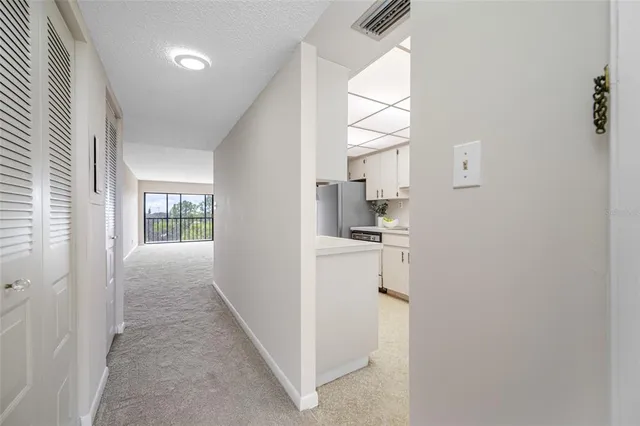 a view of a kitchen with a refrigerator and a window