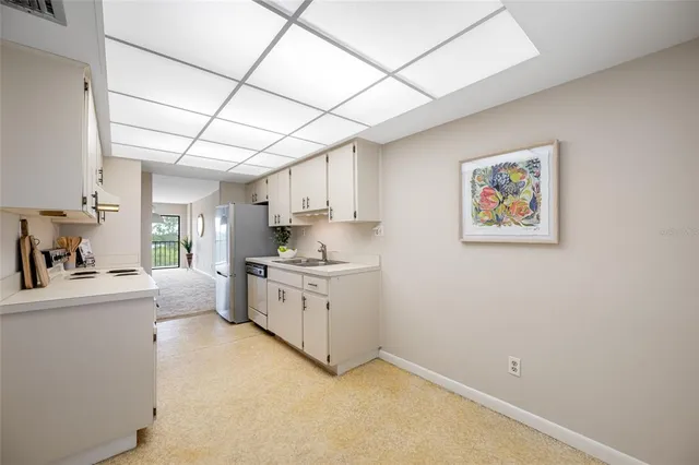 a kitchen with granite countertop a sink cabinets and window