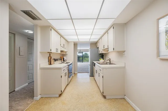 a kitchen that has a sink and a stove top oven