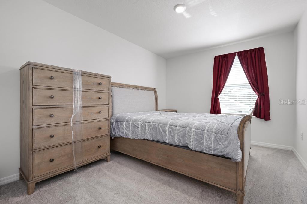 2986 Great Abaco Way Bradenton, FL 34208 - Photo 16 of 27 a bedroom with a bed and a window