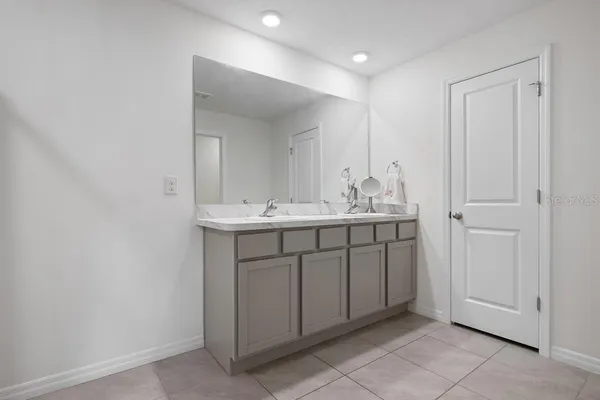 a large bed sitting in a bedroom next to a window