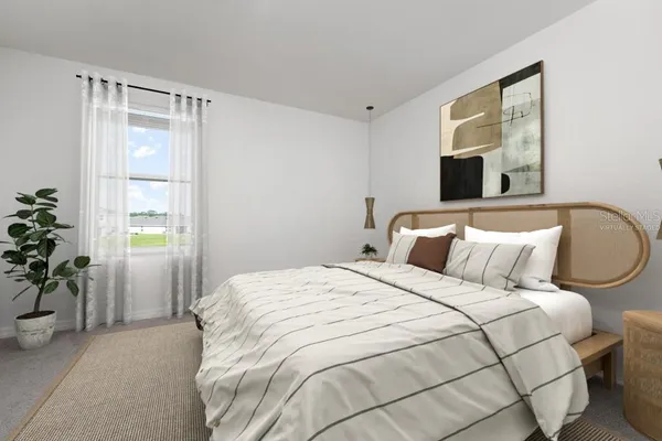 a bedroom with a bed painting on wall and a window