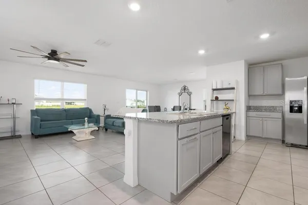 a kitchen with a sink window and cabinets