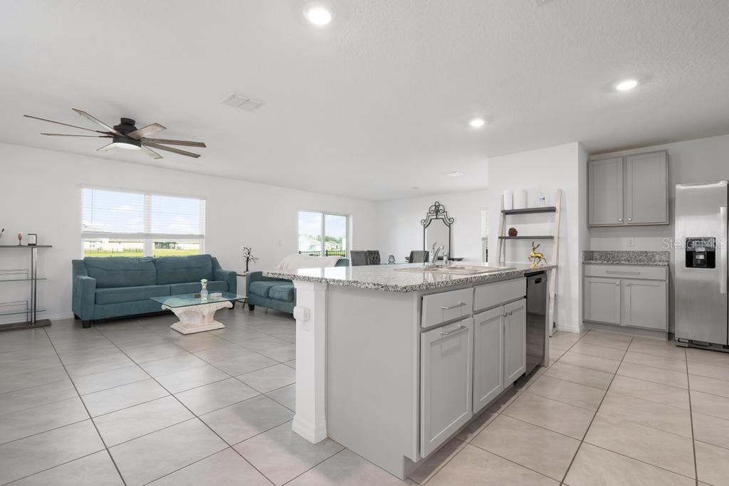 2986 Great Abaco Way Bradenton, FL 34208 - Photo 3 of 27 a kitchen with a sink window and cabinets