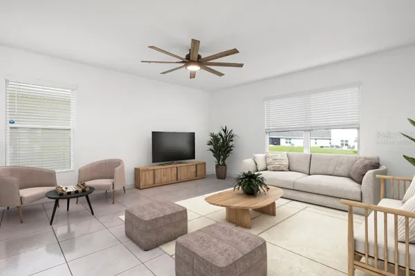 a living room with furniture a window and a flat screen tv