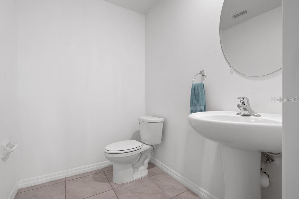2986 Great Abaco Way Bradenton, FL 34208 - Photo 9 of 27 a bathroom with a toilet sink and mirror
