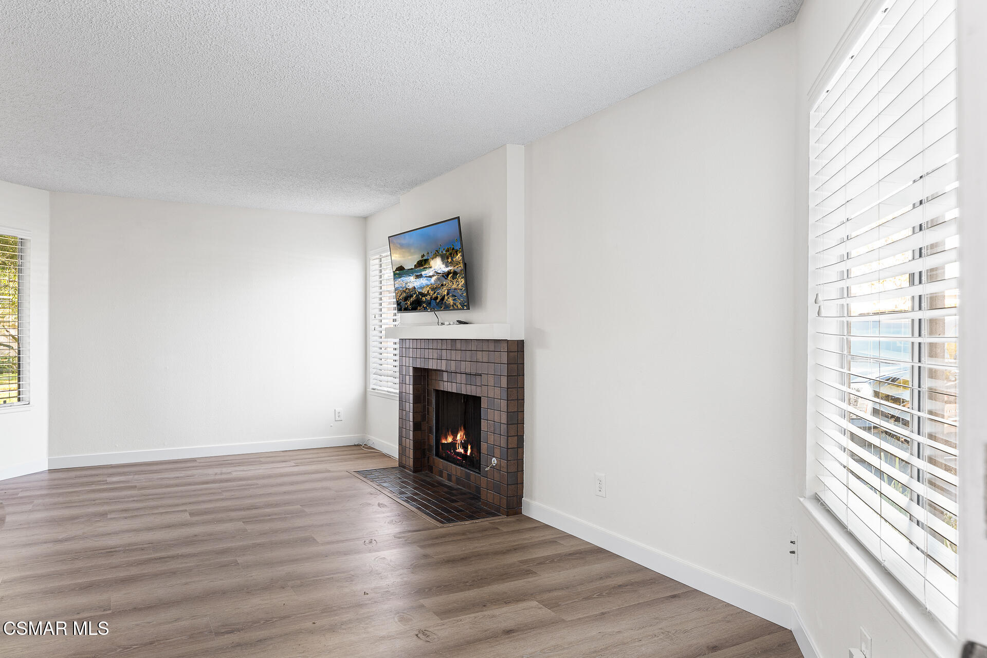 1748 Sinaloa Road, Unit 158 Simi Valley, CA 93065 - Photo 3 of 21 a view of an empty room with wooden floor and a window