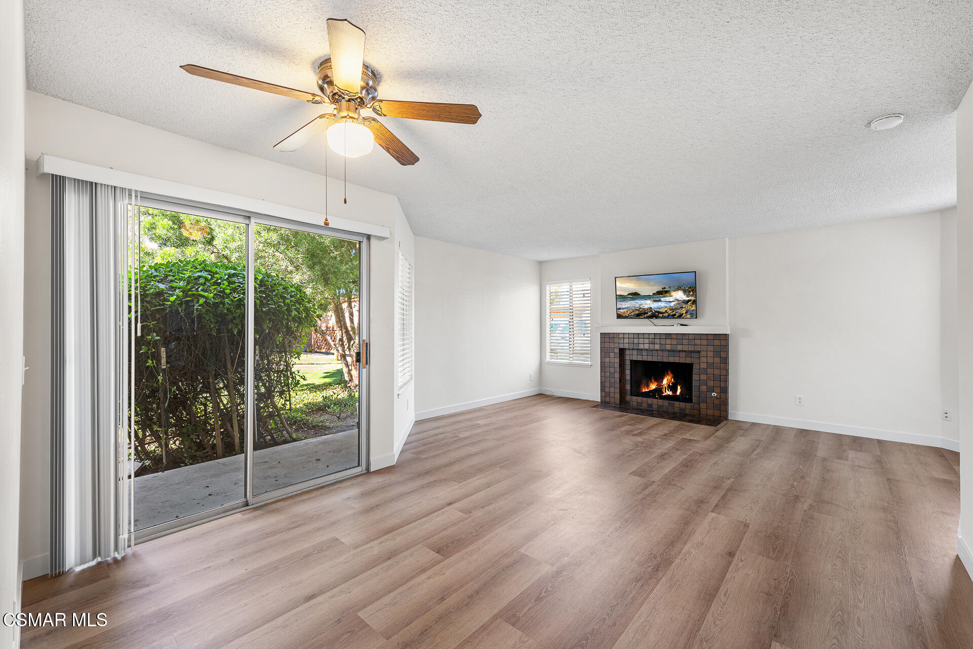 1748 Sinaloa Road, Unit 158 Simi Valley, CA 93065 - Photo 5 of 21 a view of an empty room with wooden floor fireplace and a window