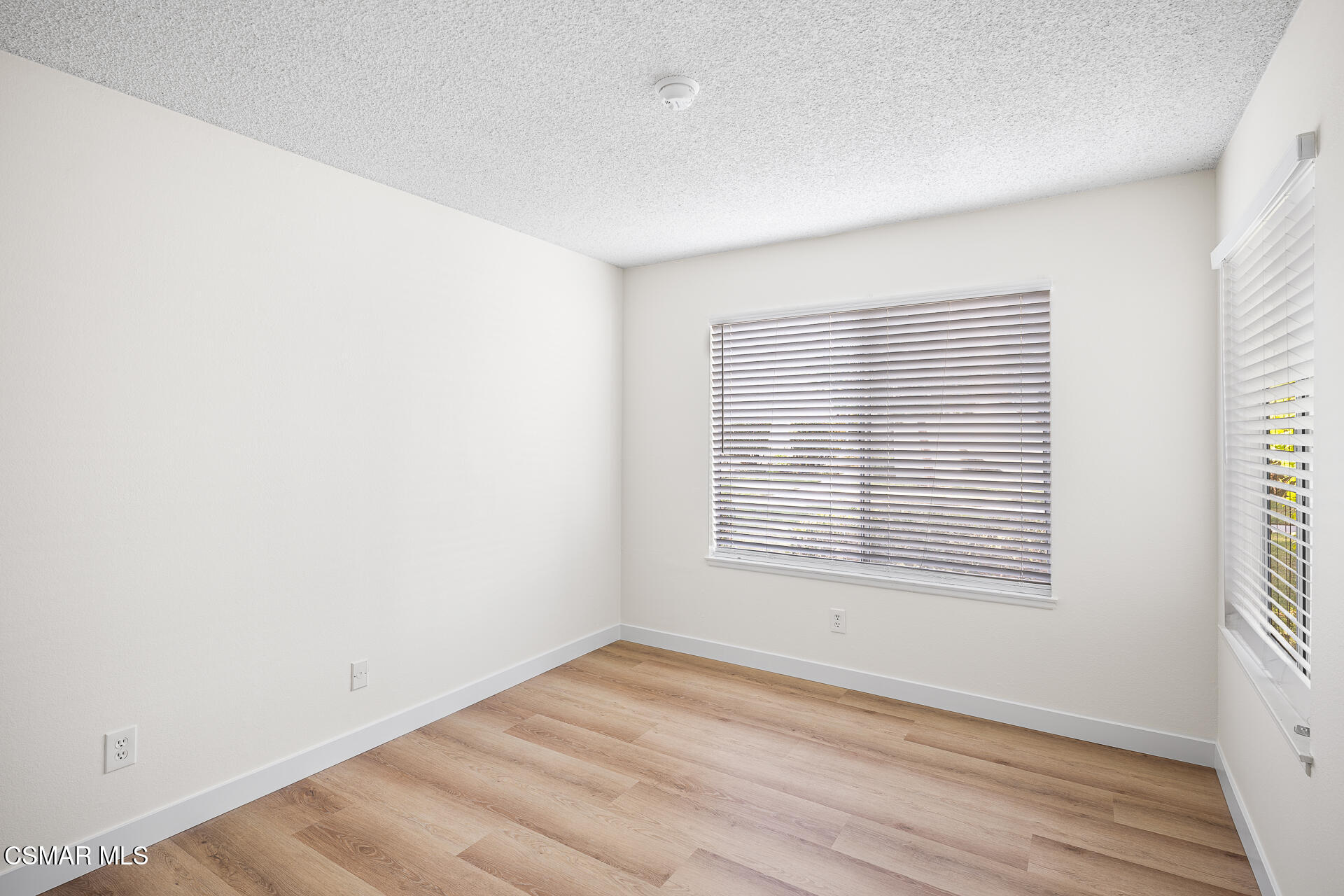 1748 Sinaloa Road, Unit 158 Simi Valley, CA 93065 - Photo 10 of 21 an empty room with wooden floor and windows