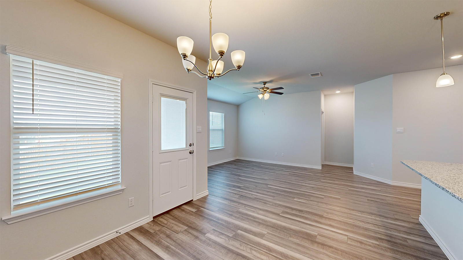 242 Water Wl Road Burnet, TX 78611 - Photo 7 of 21 a view of an empty room with wooden floor and a window