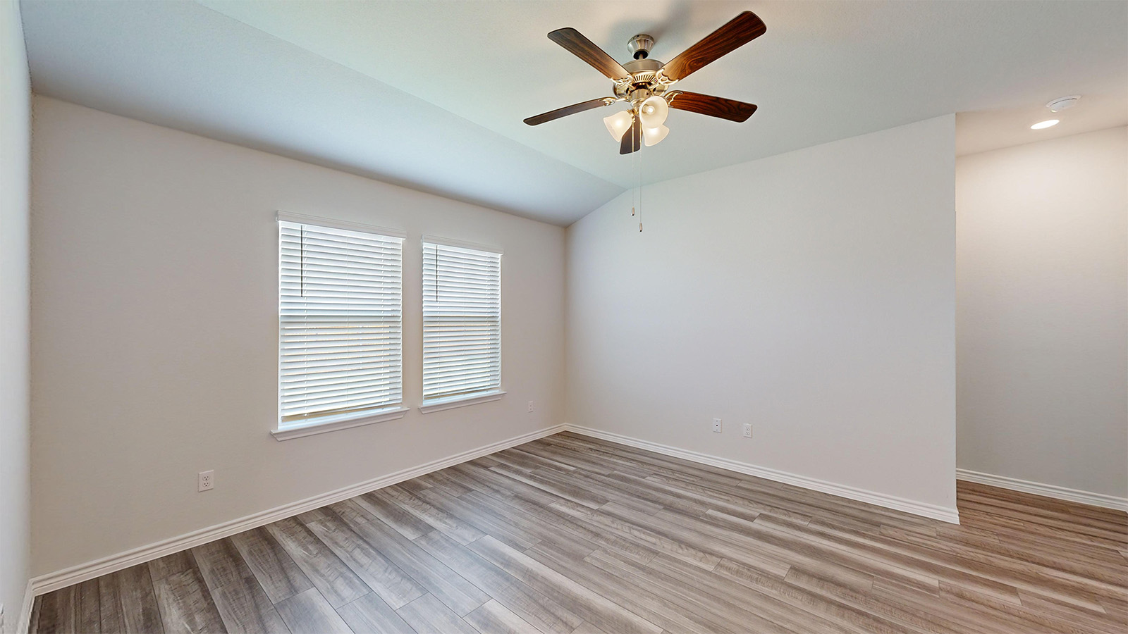 242 Water Wl Road Burnet, TX 78611 - Photo 8 of 21 an empty room with wooden floor and windows