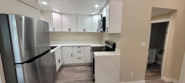 a kitchen with a refrigerator a sink and cabinets