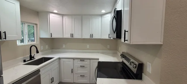 a kitchen with a sink and cabinets