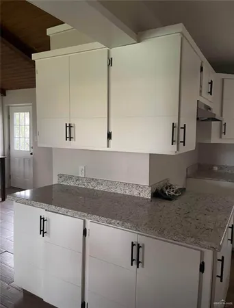 a kitchen with a sink and cabinets