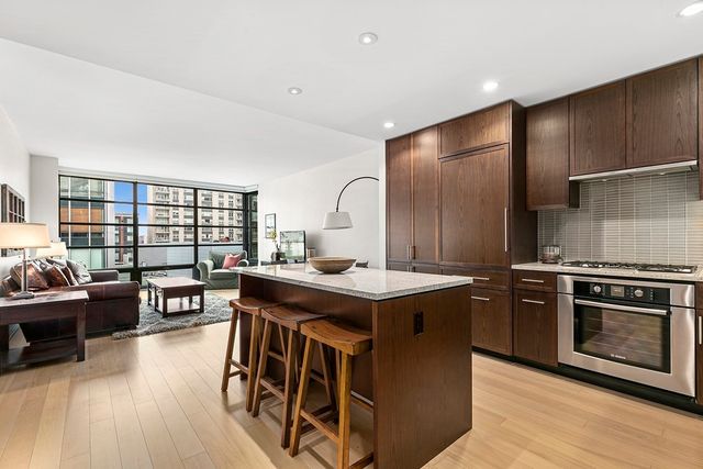 a kitchen with stainless steel appliances granite countertop a stove and a refrigerator