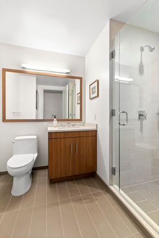 a bathroom with a toilet sink and shower