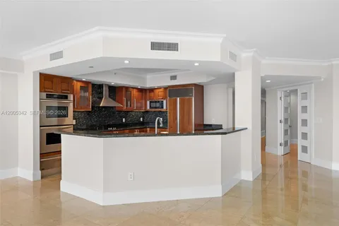 a kitchen with granite countertop a sink and cabinets