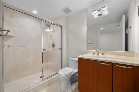 a view of an empty room with wooden floor and a sliding door